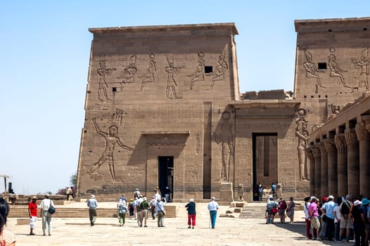 Aswan, Egypt - April 17 2008: Tourists visiting the Philae temple near the Aswan dam on the Nile. Egypt