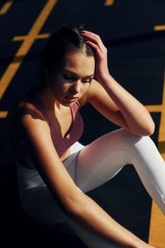 Natural lighting. Beautiful young woman with slim body type is in the gym.