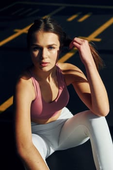 Natural lighting. Beautiful young woman with slim body type is in the gym.