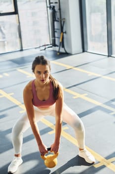 In the gym. Beautiful young woman with slim body type.