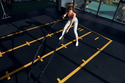 Active lifestyle. Beautiful young woman with slim body type is in the gym.