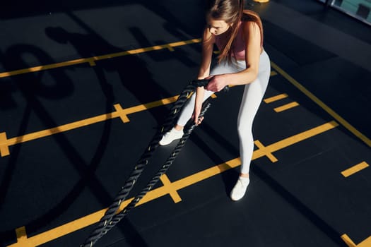 Active lifestyle. Beautiful young woman with slim body type is in the gym.