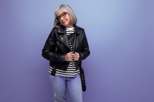 energetic mature woman in a stylish jacket on a bright background.