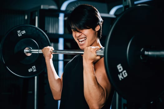 A muscular male bodybuilder lifting heavy barbells in the gym for a power-building workout that showcases his impressive physique. power lifting training concept