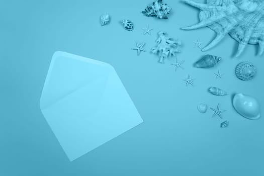 Blue background with envelope and shells and starfish