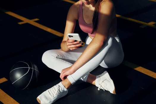 Weekend activities. Beautiful young woman with slim body type is in the gym.