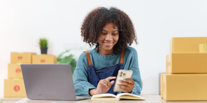 Beautiful American African woman completes KYC using an online banking program in order to open a digital savings account. The definition of cyber security.