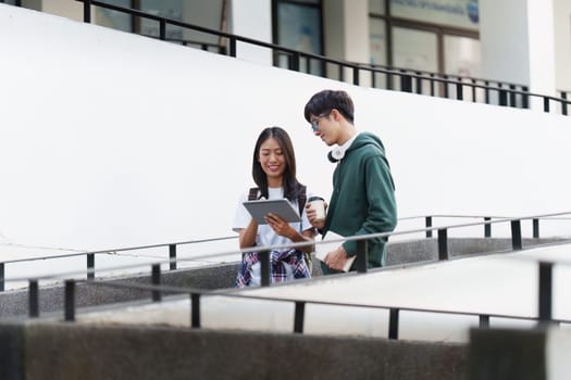 Young Asian woman college student with friends at outdoors. College student working on the college campus, education, school, study.