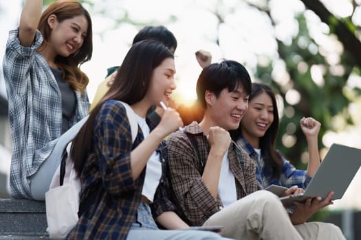 Young Asian woman college student with friends at outdoors. College student working on the college campus, education, school, study.