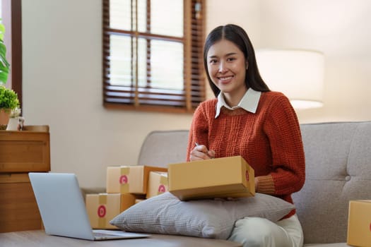 Small businesses SME owners female entrepreneurs check online orders to prepare to pack the boxes, sell to customers, sme business ideas online.