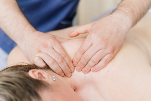 Young fat woman getting massage treatment in a day spa cabinet.