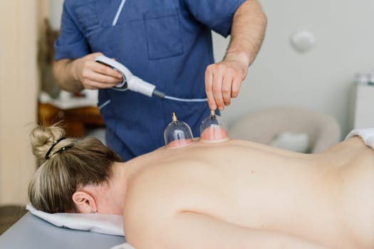 Young fat woman getting massage treatment in a day spa cabinet.