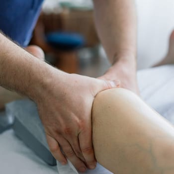 Young fat woman getting massage treatment in a day spa cabinet.