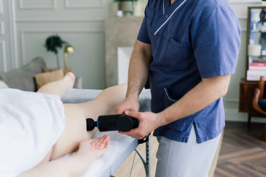 Young fat woman getting massage treatment in a day spa cabinet.