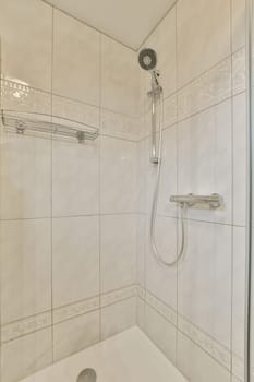 a bathroom with a shower head and hand held in front of the bathtub that is attached to the wall