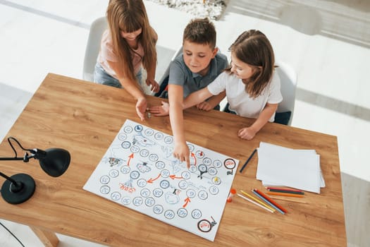 Step by step game. Kids having fun in the domestic room at daytime together.