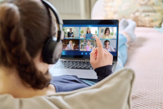 Video conference, teenage girl student looking at laptop screen with group of teenagers studying remotely at home. Online lesson distance learning course. E-learning e-education technology high school