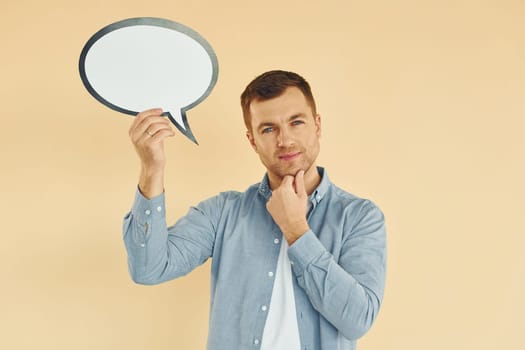Positive emotions. Man standing in the studio with empty signs for the text.