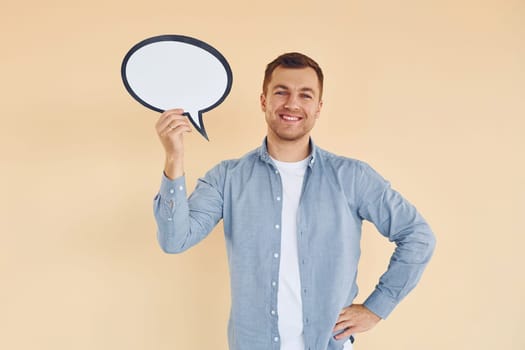 Positive emotions. Man standing in the studio with empty signs for the text.