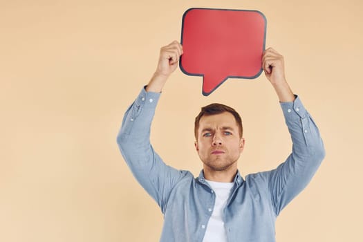 Facial expression. Man standing in the studio with empty signs for the text.