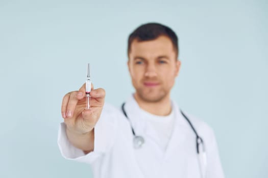 Doctor in uniform standing in the studio.