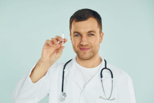 Doctor in uniform standing in the studio.