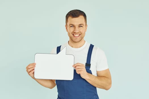 Worker saying something. Man standing in the studio with empty signs for the text.