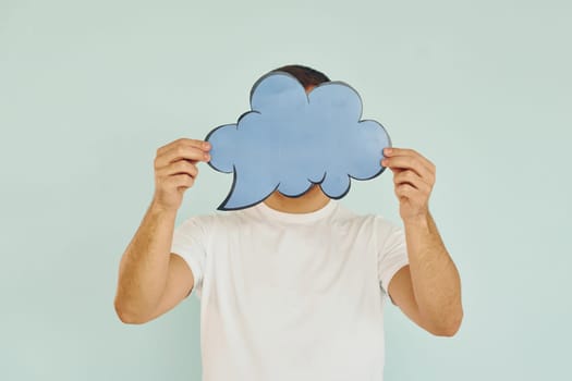 Cloud looking signs. Man standing in the studio.