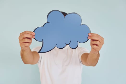 Cloud looking signs. Man standing in the studio.