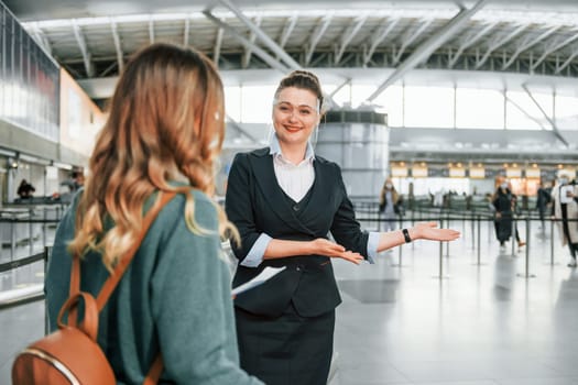 Pass procedure. Young female tourist is in the airport at daytime.