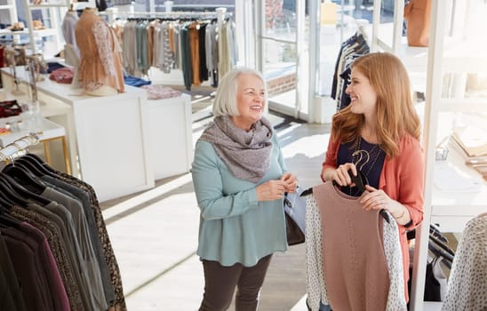 I know quite a lot about fashion dear. a mother and daughter shopping in a clothing boutique