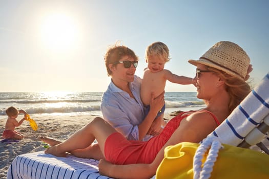 Summertime is family time. a family spending the day at the beach together