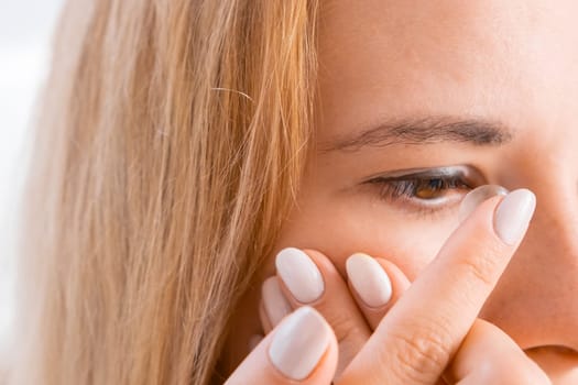 Young woman applying contact lenses for improvement of vision