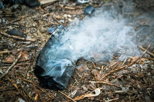 A piece of broken glass with smoke coming out of it. High quality photo