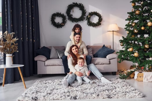 Conception of holidays. Family celebrating new year with their children at home.