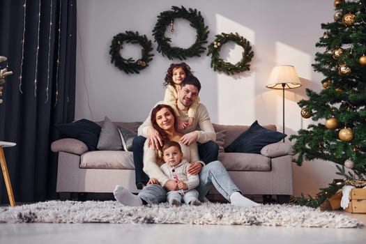 Conception of holidays. Family celebrating new year with their children at home.