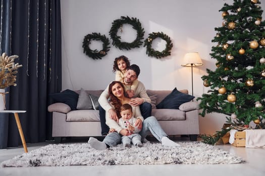 Conception of holidays. Family celebrating new year with their children at home.