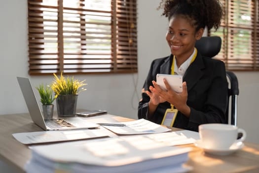 Accountant black woman working on laptop and calculator for do document, tax, exchange, accounting and Financial advisor concept. Close up.