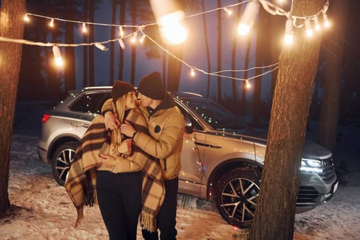 Conception of love. Couple standing in the forest and celebrating New year.