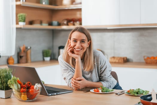 Woman preparing food at home on the modern kitchen.