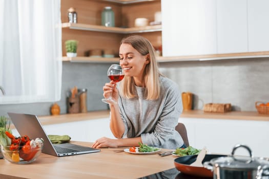 Woman preparing food at home on the modern kitchen.