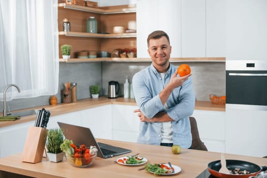 Man preparing food at home on the modern kitchen.
