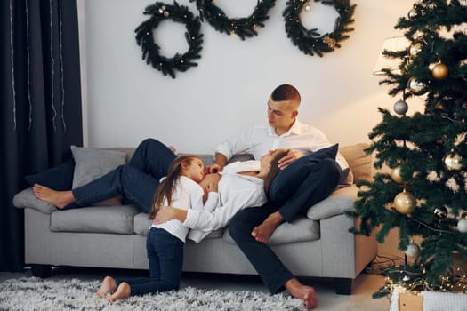 Christmas decoration. Happy family celebrating holidays indoors together.