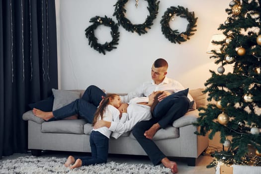 Christmas decoration. Happy family celebrating holidays indoors together.