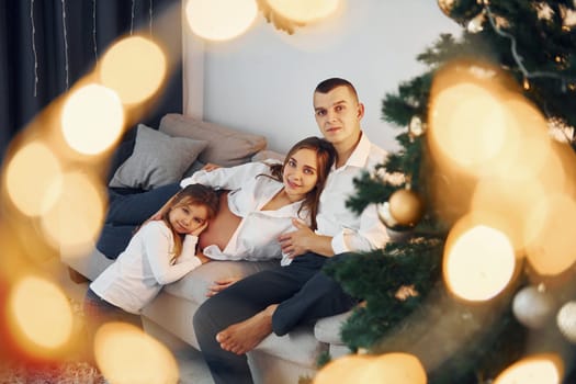 Happy family celebrating holidays indoors together.