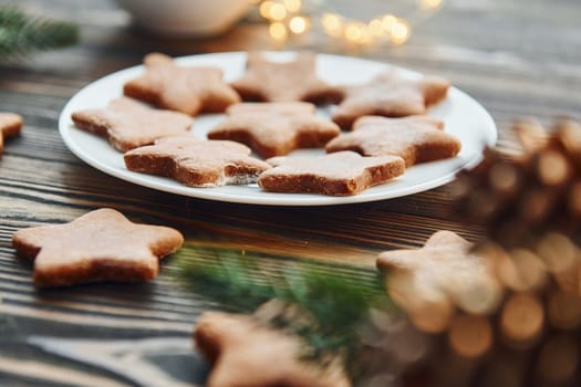 Cookies is on the plate. Christmas background with holiday decoration.