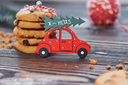 Red toy car. Christmas background with holiday decoration.