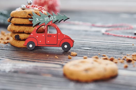 Red toy car. Christmas background with holiday decoration.