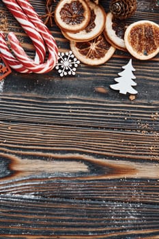 Candies and slices of oranges. Christmas background with holiday decoration.