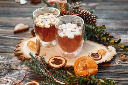 Glasses with hot drink. Christmas background with holiday decoration.